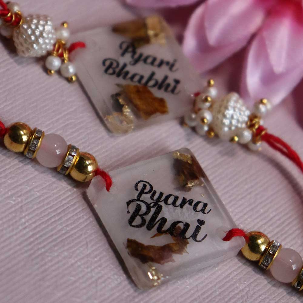 Transparent Resin Couple Rakhi - Image 2